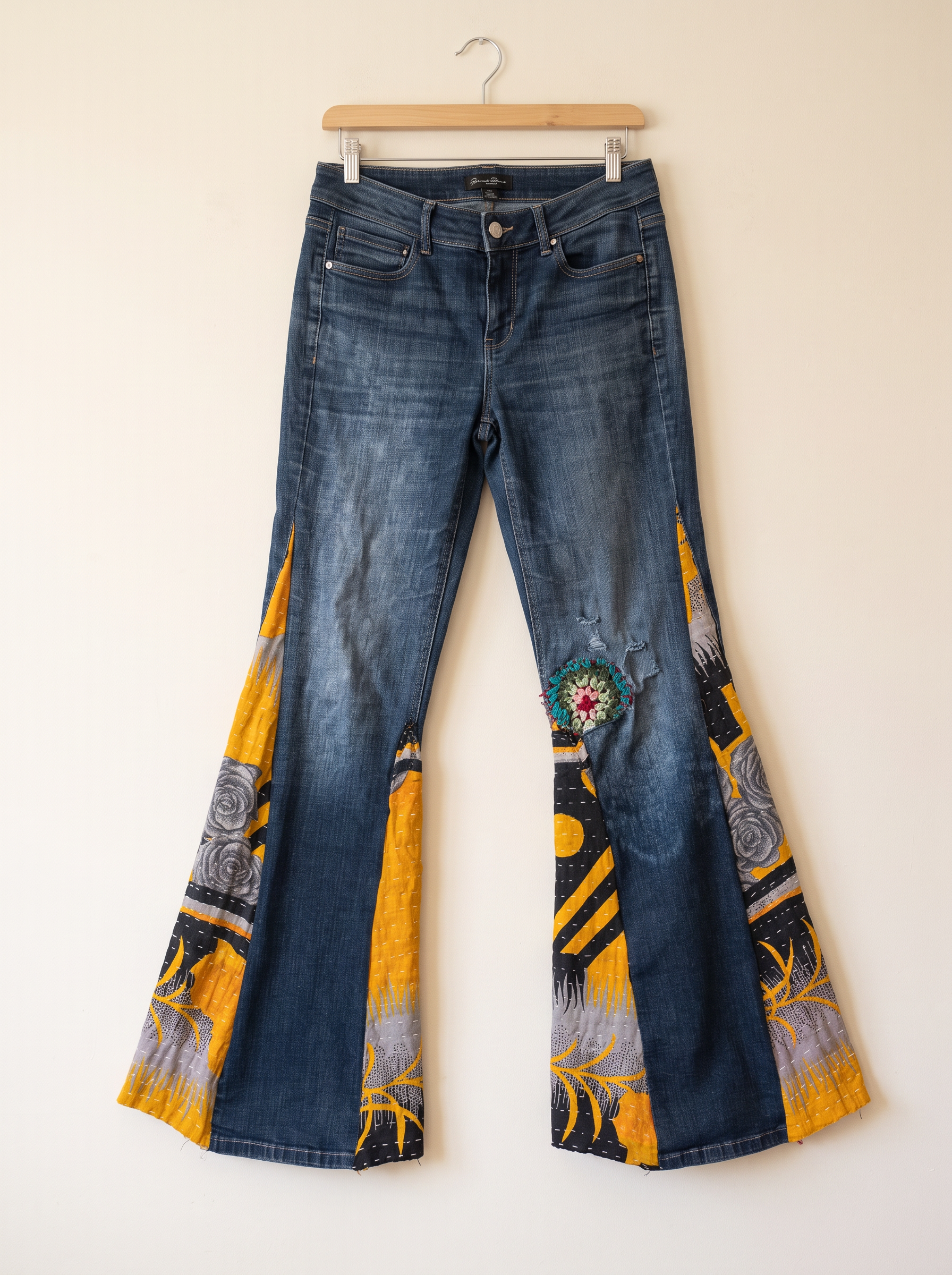Flared denim with yellow patterned panels and a crochet knee detail — standalone boutique preview
